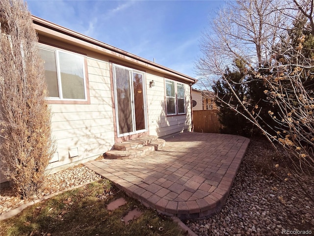 view of patio featuring entry steps and fence