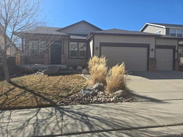 view of front of home with an attached garage, concrete driveway, and brick siding