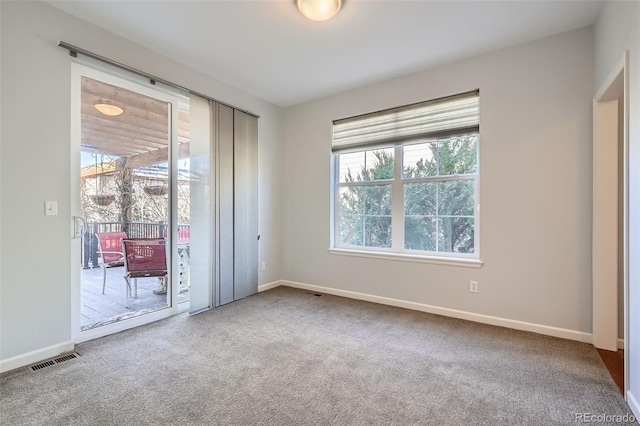 unfurnished bedroom featuring access to exterior and carpet floors