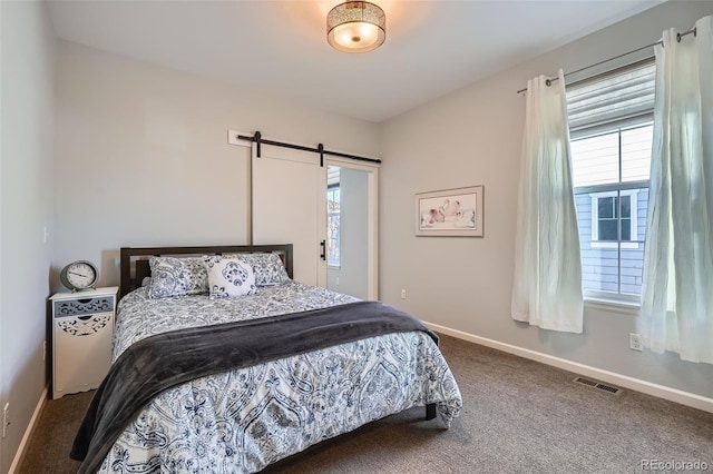 bedroom featuring carpet flooring and a barn door