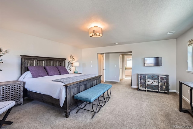 bedroom featuring carpet floors and a textured ceiling