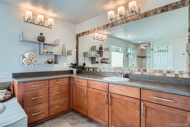 bathroom featuring a shower, vanity, and tile patterned flooring