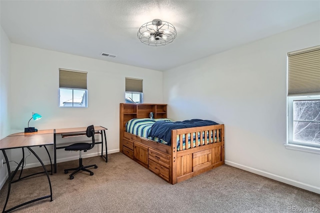 bedroom with light colored carpet