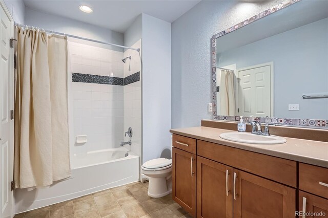 full bathroom featuring tile patterned floors, shower / bath combination with curtain, toilet, and vanity