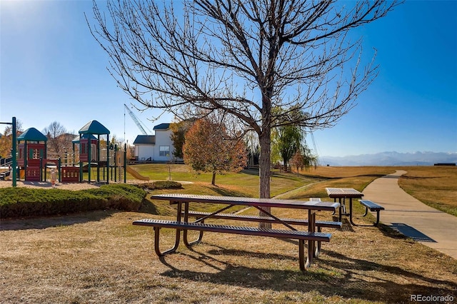 view of property's community featuring a playground and a yard