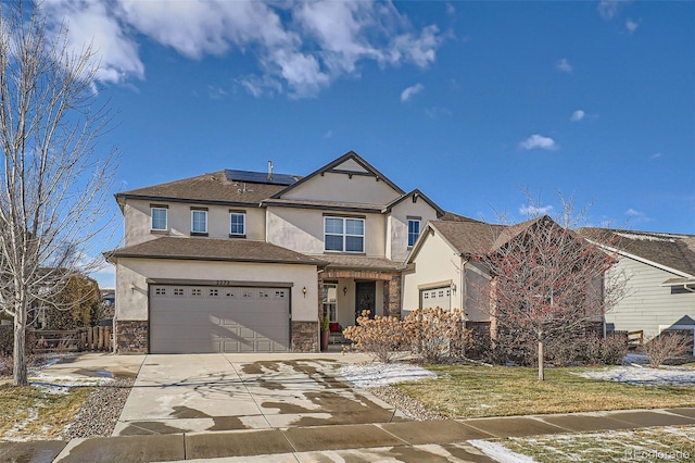 view of front of home with a garage and solar panels