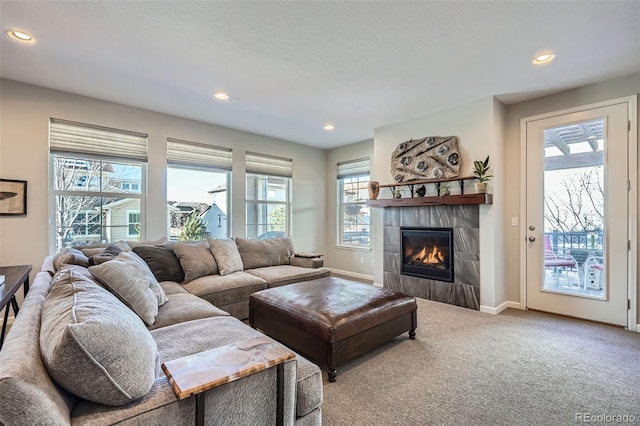 carpeted living room featuring a healthy amount of sunlight and a tile fireplace