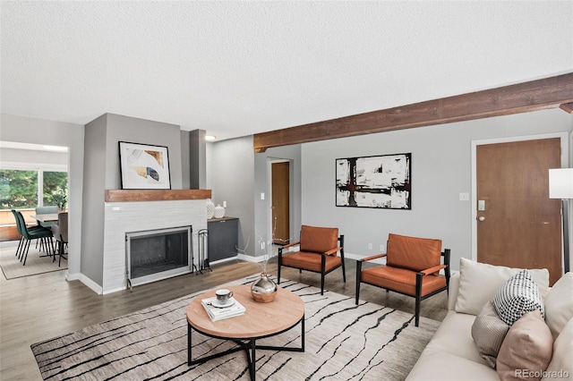 2973 Mesa Rd Unit C, Colorado Springs, CO 80904 - living room with a textured ceiling, wood finished floors, and a tiled fireplace
