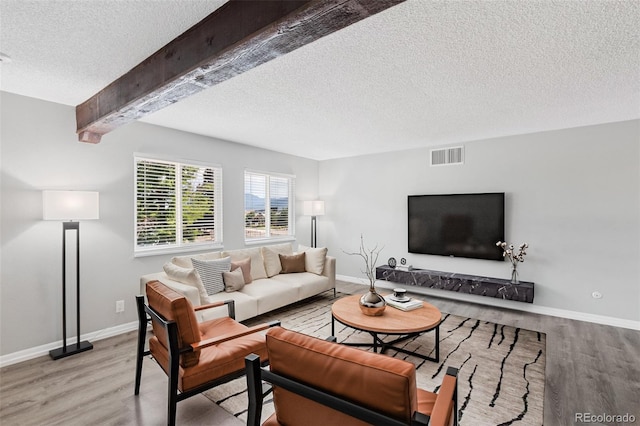 2973 Mesa Rd Unit C, Colorado Springs, CO 80904 - living area with a textured ceiling, light wood finished floors, and beamed ceiling
