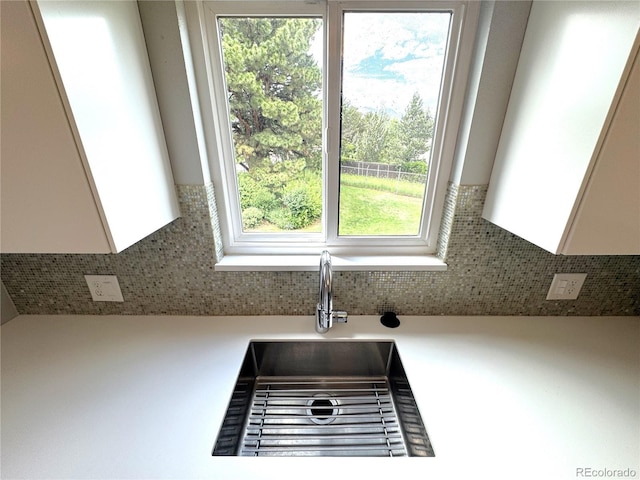 2973 Mesa Rd Unit C, Colorado Springs, CO 80904 - kitchen view of white cabinets, backsplash, and light countertops