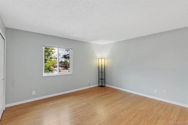 2973 Mesa Rd Unit C, Colorado Springs, CO 80904 - unfurnished room featuring light wood-style flooring and a textured ceiling