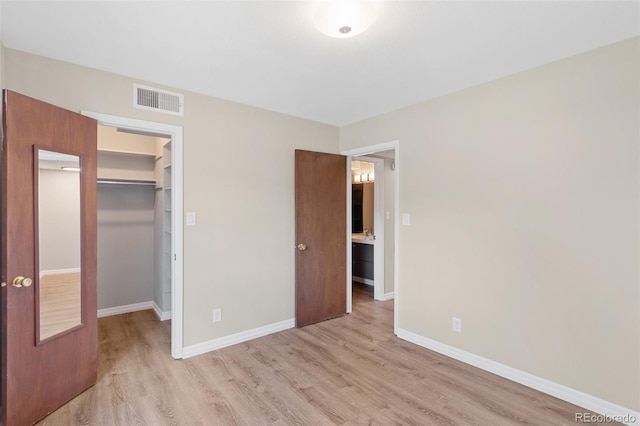 2973 Mesa Rd Unit C, Colorado Springs, CO 80904 - unfurnished bedroom with light wood-style flooring and a walk in closet