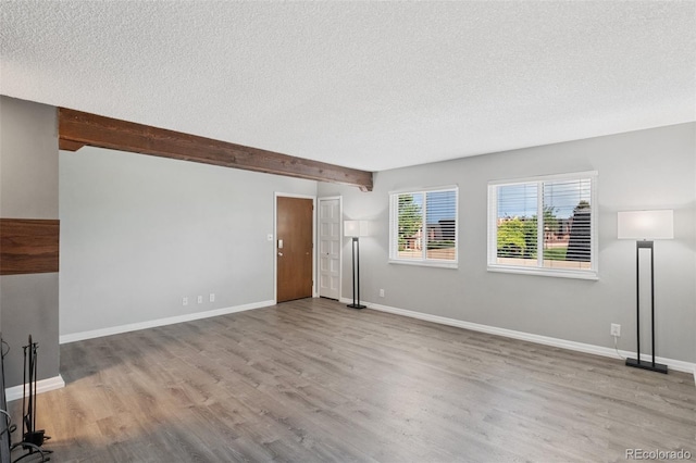 2973 Mesa Rd Unit C, Colorado Springs, CO 80904 - unfurnished living room featuring a textured ceiling, wood finished floors, and beam ceiling