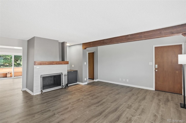 2973 Mesa Rd Unit C, Colorado Springs, CO 80904 - unfurnished living room with a fireplace, wood finished floors, and a textured ceiling