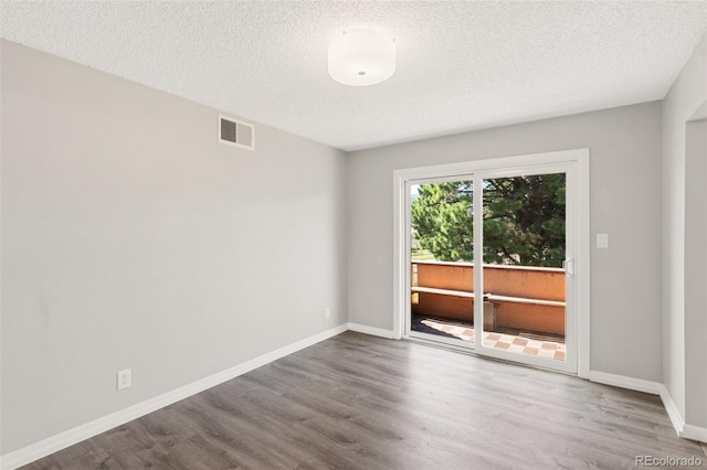 2973 Mesa Rd Unit C, Colorado Springs, CO 80904 - empty room featuring wood finished floors and a textured ceiling
