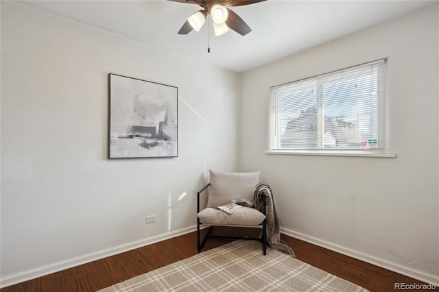 sitting room with ceiling fan, light wood-style flooring, and baseboards