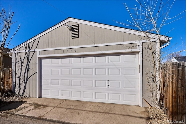 detached garage featuring fence