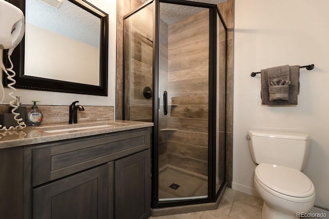 bathroom with tile patterned flooring, a textured ceiling, an enclosed shower, toilet, and vanity