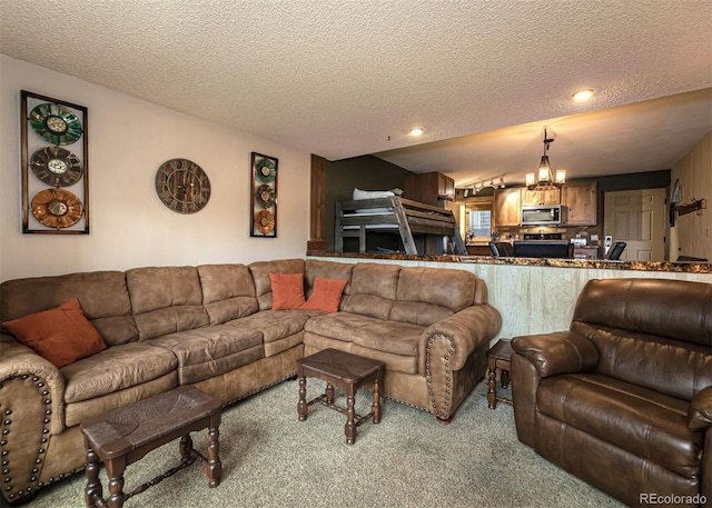 carpeted living room featuring a chandelier and a textured ceiling