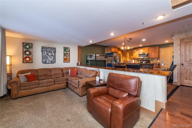 living room featuring light hardwood / wood-style flooring and a notable chandelier