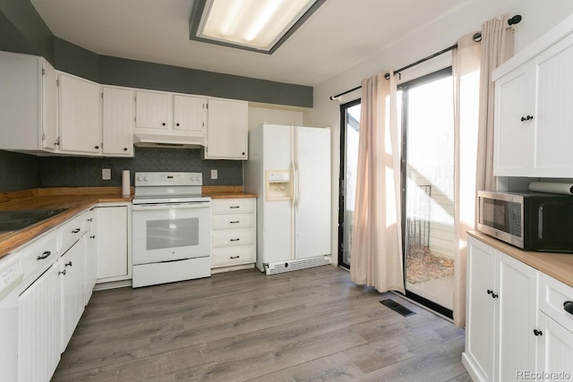 kitchen featuring decorative backsplash, hardwood / wood-style floors, white appliances, and white cabinetry