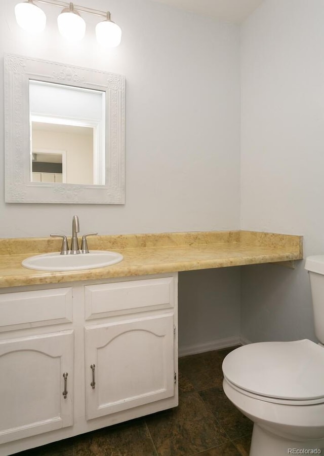 bathroom featuring vanity and toilet