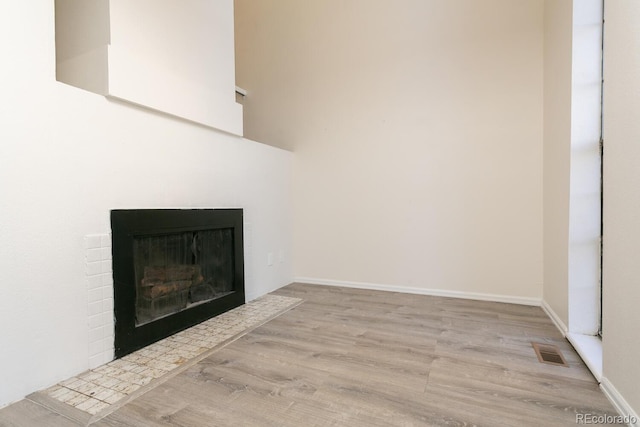 7900 W Layton Ave Unit 833, Littleton, CO 80123 - detailed view of wood finished floors, a fireplace with flush hearth, and baseboards