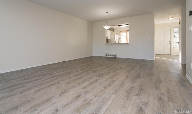 7900 W Layton Ave Unit 833, Littleton, CO 80123 - unfurnished room with wood finished floors, baseboards, and a sink