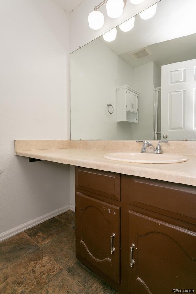 7900 W Layton Ave Unit 833, Littleton, CO 80123 - bathroom with vanity, baseboards, a shower with shower door, and stone finish floors