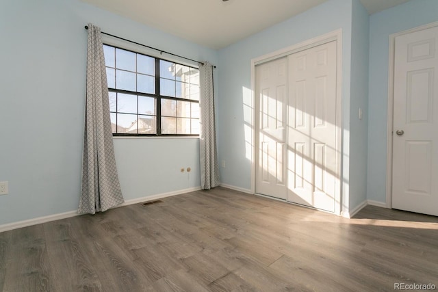 spare room with hardwood / wood-style floors