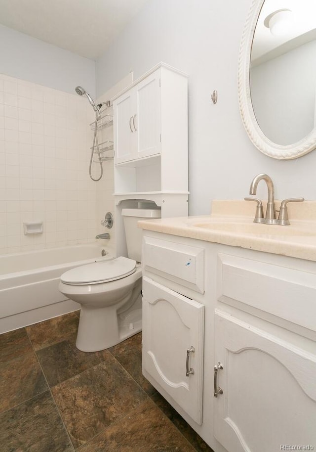 full bathroom featuring vanity, tiled shower / bath combo, and toilet