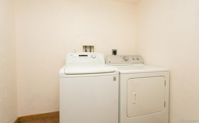 7900 W Layton Ave Unit 833, Littleton, CO 80123 - laundry area with washer and clothes dryer, baseboards, and tile patterned flooring