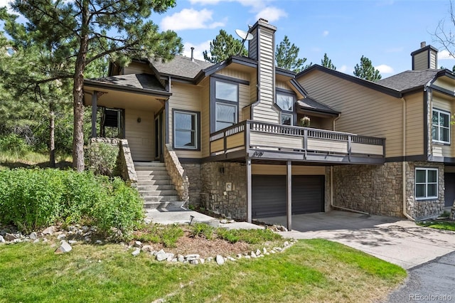 4219 Morning Star Dr, Castle Rock, CO 80108 - rear view of property featuring a chimney, driveway, stone siding, a garage, and roof with shingles