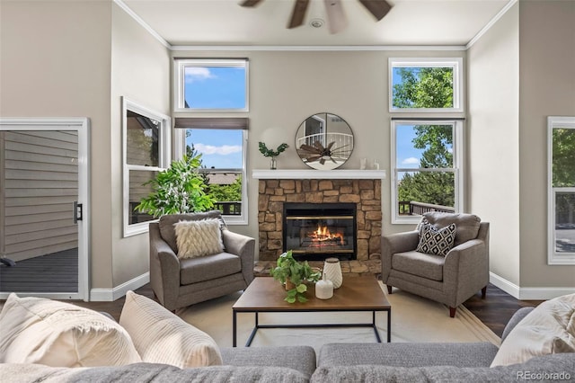 4219 Morning Star Dr, Castle Rock, CO 80108 - living area with a ceiling fan, crown molding, wood finished floors, a fireplace, and a towering ceiling