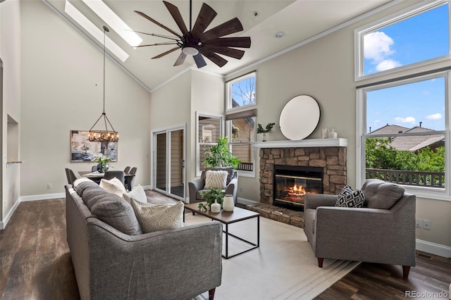 4219 Morning Star Dr, Castle Rock, CO 80108 - living room with high vaulted ceiling, a ceiling fan, crown molding, wood finished floors, and a fireplace