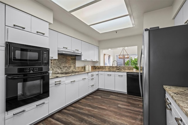 4219 Morning Star Dr, Castle Rock, CO 80108 - kitchen featuring black appliances, a chandelier, white cabinets, under cabinet range hood, and decorative backsplash