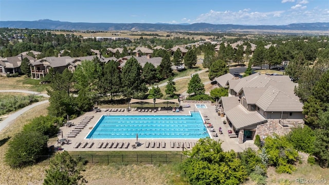 4219 Morning Star Dr, Castle Rock, CO 80108 - aerial perspective of suburban area with a pool and a mountain backdrop