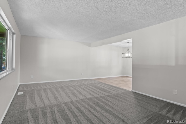 6240 W 110th Pl, Westminster, CO 80020 - carpeted spare room featuring a chandelier and a textured ceiling