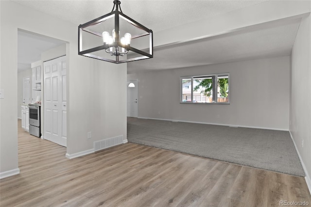 6240 W 110th Pl, Westminster, CO 80020 - spare room featuring a chandelier and wood finished floors