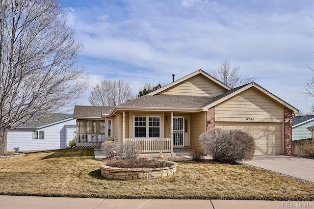 view of front of house featuring a garage, covered porch, and a front lawn