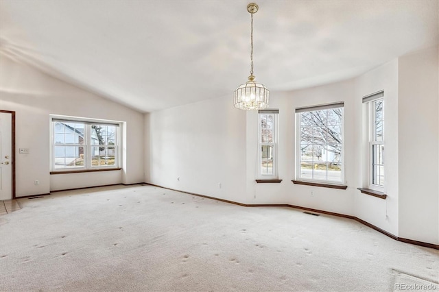 unfurnished dining area featuring an inviting chandelier, lofted ceiling, and carpet floors