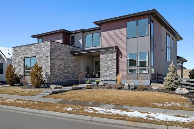 contemporary house with stone siding