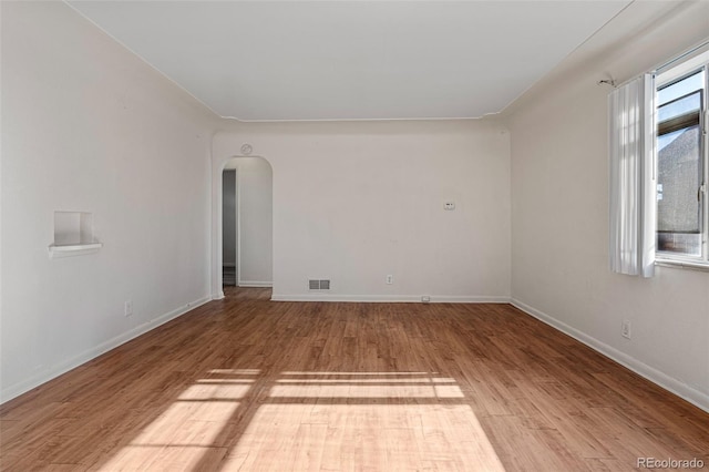 spare room featuring wood-type flooring