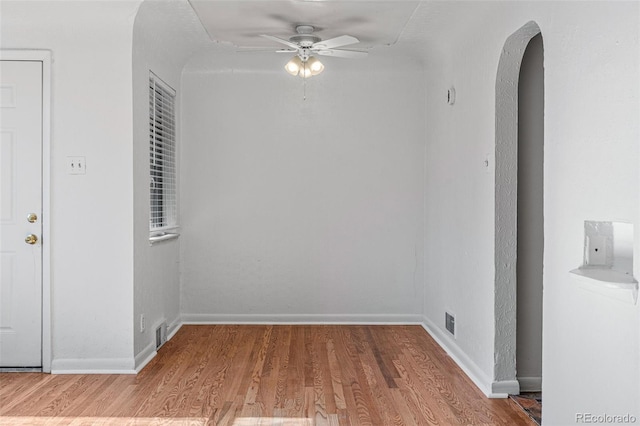 empty room with hardwood / wood-style floors and ceiling fan