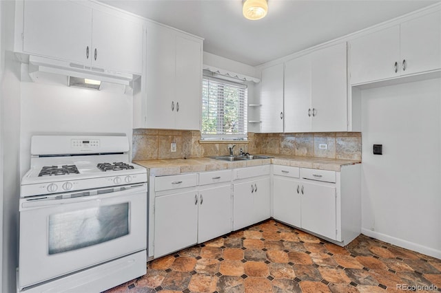 kitchen with sink, white cabinetry, backsplash, and gas range gas stove