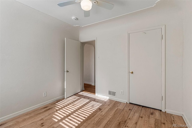 unfurnished bedroom with ceiling fan, a closet, and light hardwood / wood-style floors