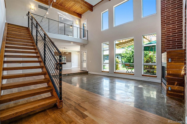 4258 Tennyson St Unit 101, Denver, CO 80212 - foyer entrance featuring a towering ceiling, stairs, plenty of natural light, and a wood ceiling with exposed beams