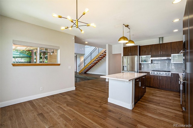4258 Tennyson St Unit 101, Denver, CO 80212 - kitchen with stainless steel refrigerator with ice dispenser, cooktop, a kitchen island, a chandelier, and dark brown cabinets