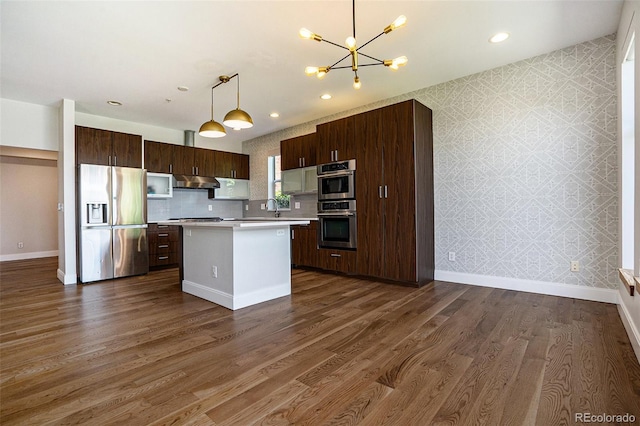 4258 Tennyson St Unit 101, Denver, CO 80212 - kitchen featuring stainless steel fridge with ice dispenser, wallpapered walls, under cabinet range hood, light countertops, and a chandelier