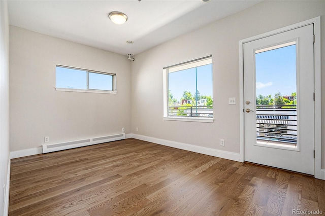 4258 Tennyson St Unit 101, Denver, CO 80212 - empty room featuring a baseboard radiator and wood finished floors